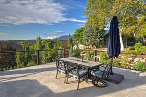 View of patio with outdoor dining area and a mountain view