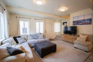 Living room featuring stairs and healthy amount of natural light