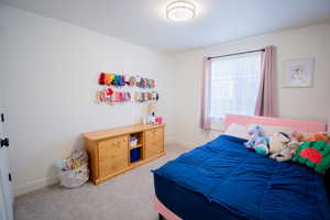 Carpeted bedroom featuring baseboards