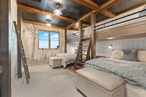 Bedroom featuring carpet floors and beamed ceiling