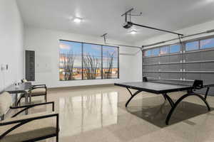 Garage featuring electric panel and a garage door opener