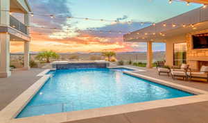 View of pool featuring a patio and a pool with connected hot tub
