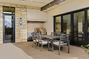 View of patio with outdoor dining space and an outdoor kitchen