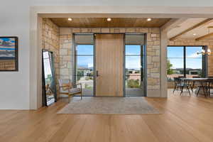 Foyer entrance featuring light wood-style flooring, a chandelier, recessed lighting, and beamed ceiling