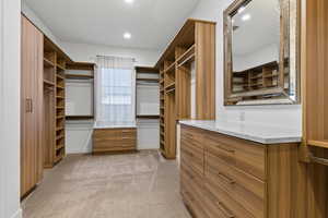 Spacious closet featuring light carpet