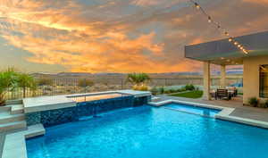 View of swimming pool with a patio area and a jacuzzi