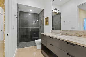 Bathroom with vanity and tiled shower