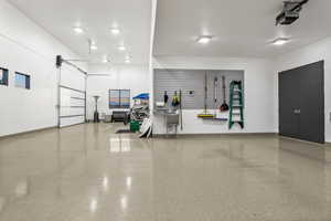 Garage with baseboards and a garage door opener
