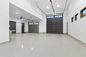 Garage featuring baseboards and a garage door opener