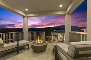 Balcony featuring a mountain view and an outdoor living space with a fire pit