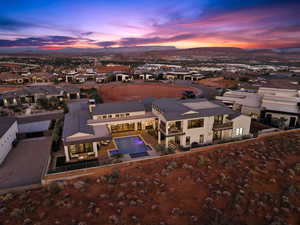 Aerial perspective of suburban area with a pool and mountains