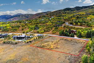 Aerial view of property's location featuring property parcel outlined and mountains