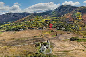 View of mountain backdrop with rural landscape