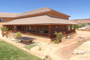 View of front of property featuring a large porch and a tiled roof