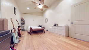 Bedroom with lofted ceiling, light wood finished floors, a ceiling fan, and recessed lighting