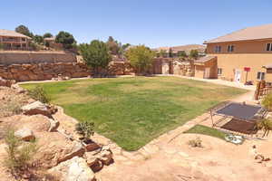 Fenced backyard with a residential view