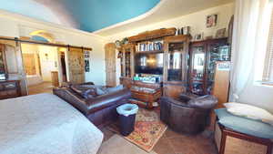 Living area featuring a barn door and tile patterned flooring