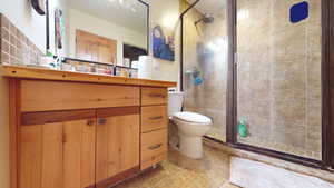 Bathroom featuring vanity, a stall shower, and light tile patterned floors