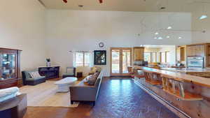 Living room featuring a high ceiling and ceiling fan