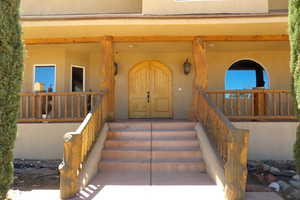 Property entrance featuring stucco siding