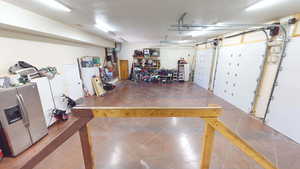 Garage with stainless steel refrigerator with ice dispenser and heating unit