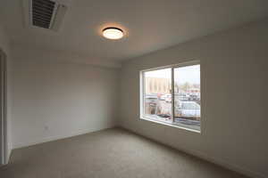 Unfurnished room with carpet flooring and baseboards