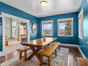 Dining room with hardwood / wood-style floors and baseboards