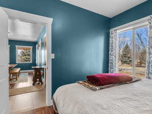 Bedroom featuring tile patterned flooring and baseboards