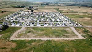 Aerial view of property and surrounding area with rural landscape, nearby suburban area, and abundant farmland