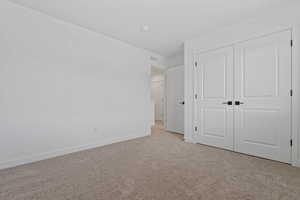 Neutral tone wall finishes, soft carpet flooring, and white trim