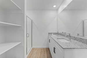 Dual vanity with granite countertops, undermount sinks, and chrome fixtures