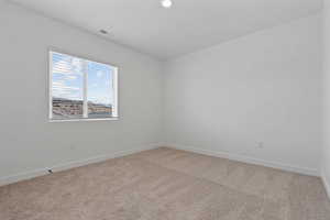 Neutral-toned carpeting complements the white walls and trim