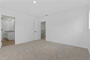 Spacious room featuring neutral carpeting and white walls