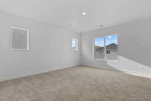 Spacious room featuring neutral carpet flooring, white painted walls, and white trim
