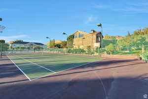 View of tennis court featuring a residential view