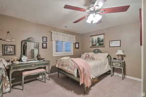 Bedroom featuring light colored carpet and a ceiling fan