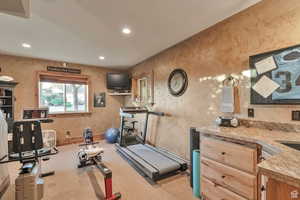 Workout room with wallpapered walls, recessed lighting, and light carpet