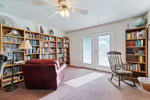 Sitting room with french doors, carpet floors, and ceiling fan