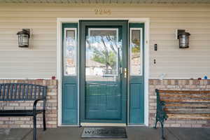 Entrance to property featuring stone siding