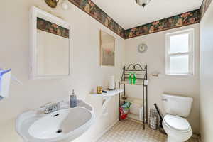 Bathroom featuring toilet and light floors