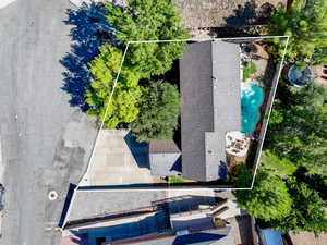 Aerial view of property and surrounding area with a pool area and property boundaries highlighted