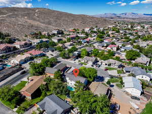 Aerial overview of property's location featuring a mountain backdrop and nearby suburban area