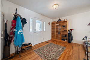 Entryway with light wood-style flooring and baseboards