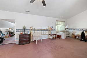 Sitting room with carpet floors and vaulted ceiling
