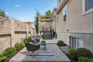 View of patio featuring a pergola, stairs, and a wooden deck