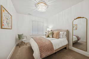 Bedroom featuring carpet floors and a chandelier