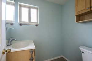 Bathroom with vanity and dark tile patterned flooring