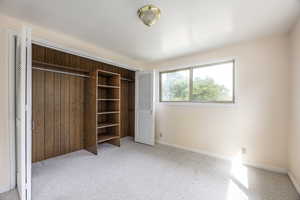 Unfurnished bedroom with a closet and light colored carpet