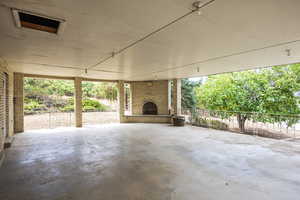 View of patio / terrace featuring an outdoor brick fireplace