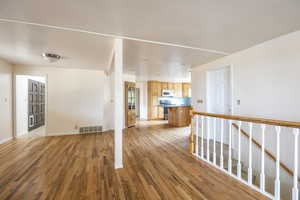 Unfurnished living room with light wood-style floors and a textured ceiling